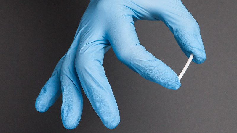 naltrexone implant in a gloved hand