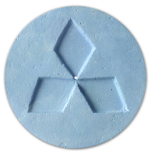 Close-up of a light blue circular ecstasy pill with the Mitsubishi logo imprinted on its surface, illustrating common branding of MDMA tablets